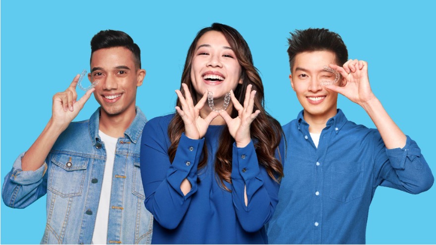 Three people holding up Zenyum Invisible Braces