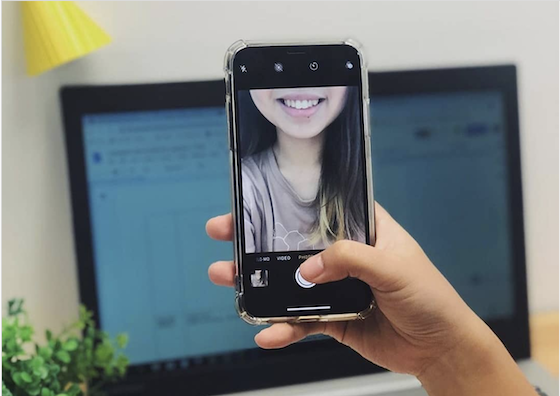 Girl taking a picture of her teeth