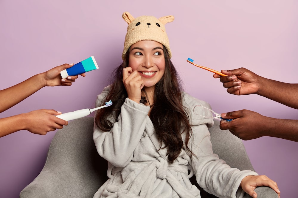 Woman surrounded by oral care products