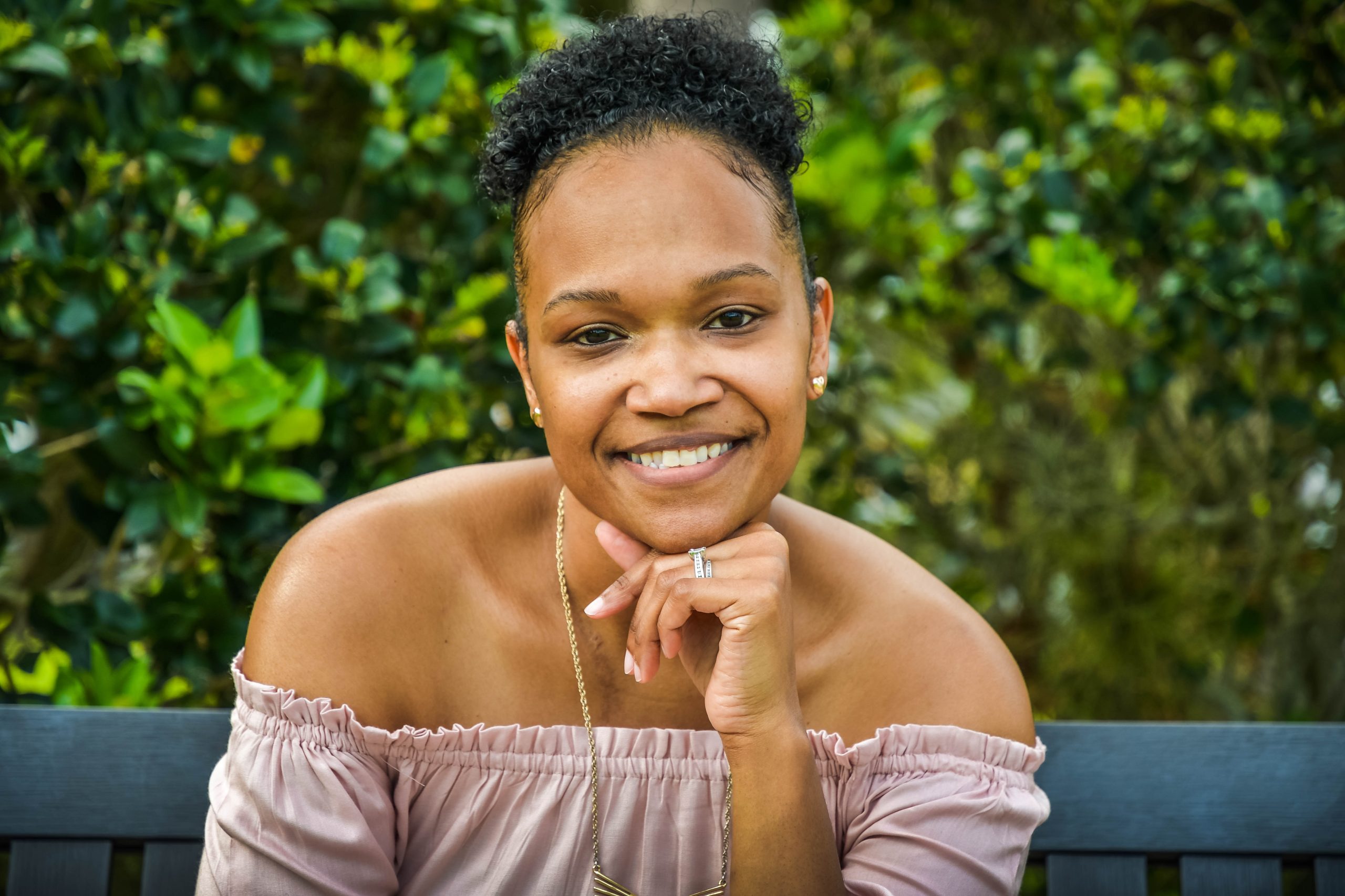 woman resting head on hand and smiling