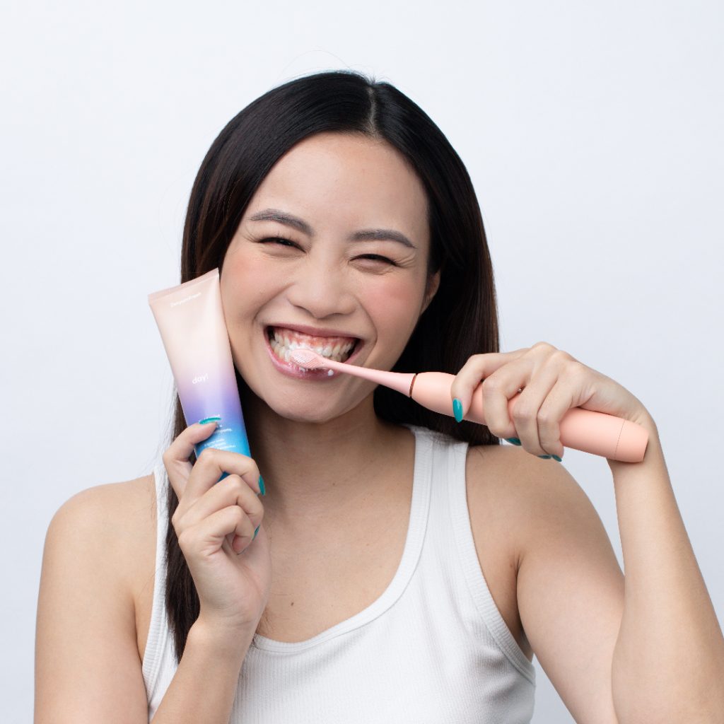 Girl using ZenyumSonic and ZenyumFresh Toothpaste Day!