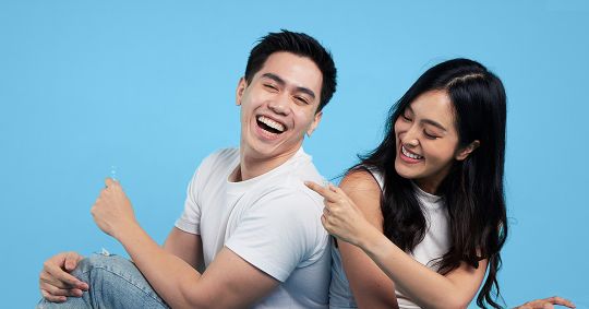 Two friends laughing and smiling