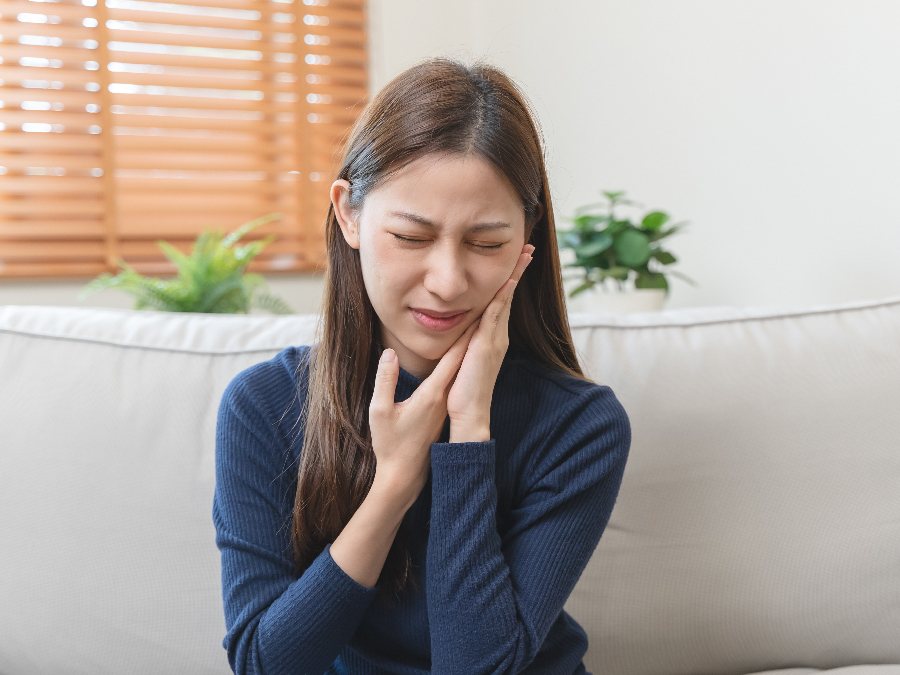 Woman suffering from jaw pain