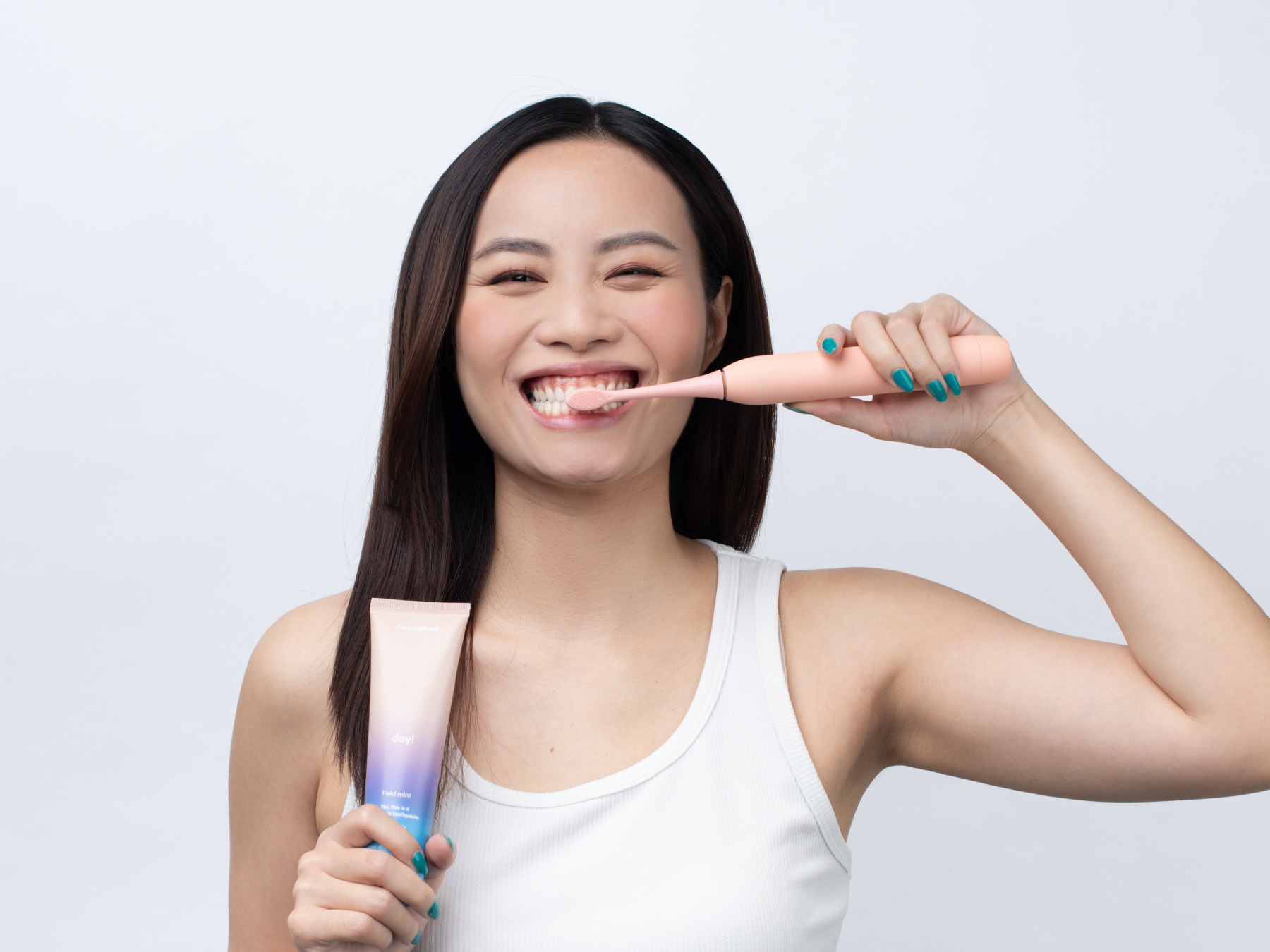 Girl brushing her teeth with ZenyumSonic Electric Toothbrush
