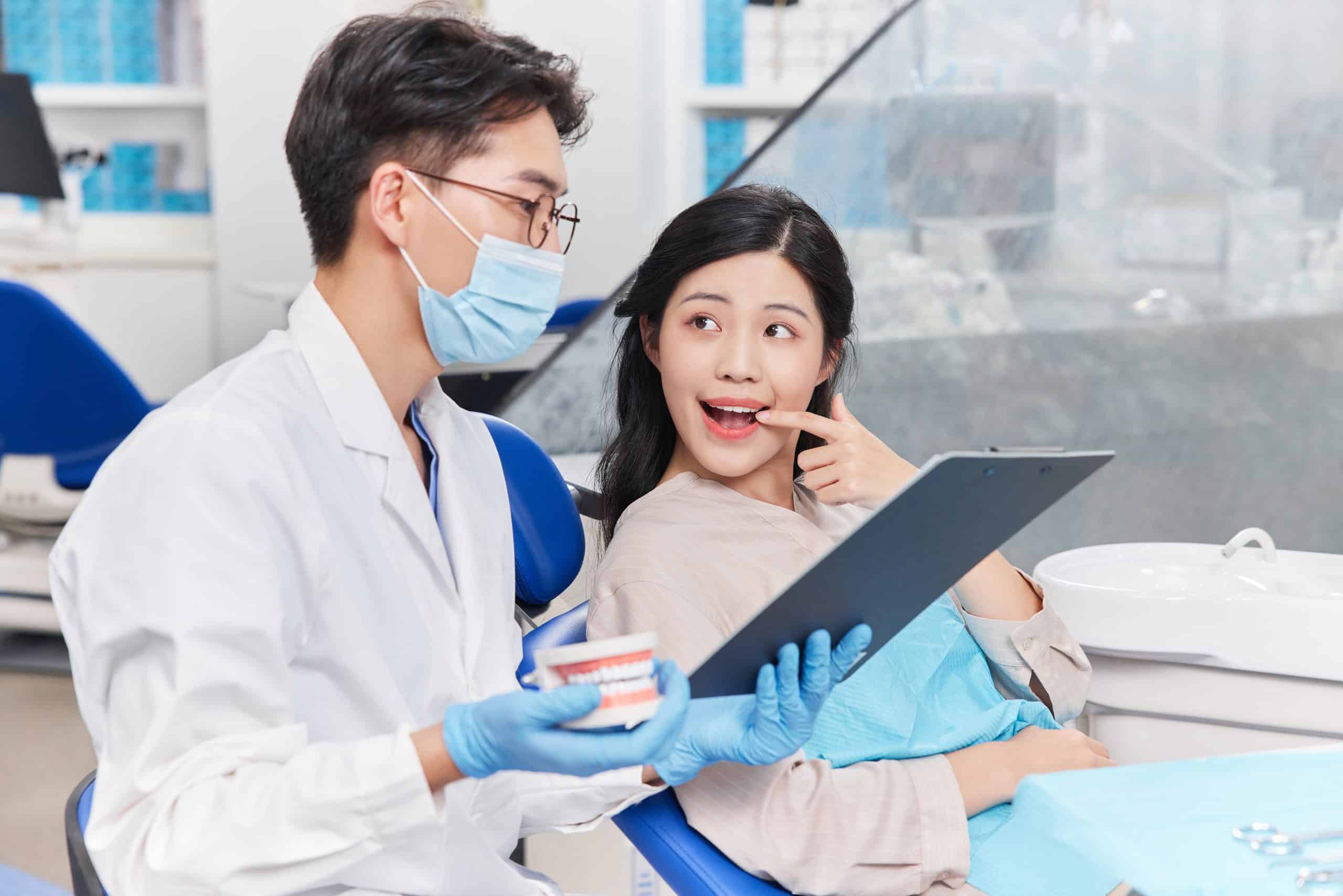 After the doctor washes the teeth of a woman, he/she explains and describes her tooth.