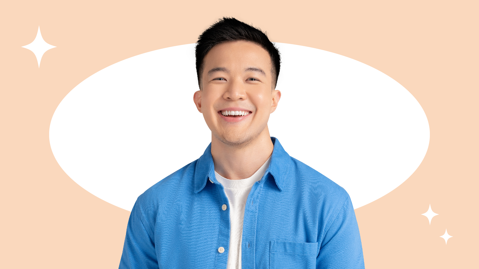 Men in blue shirt smiling in peach background color