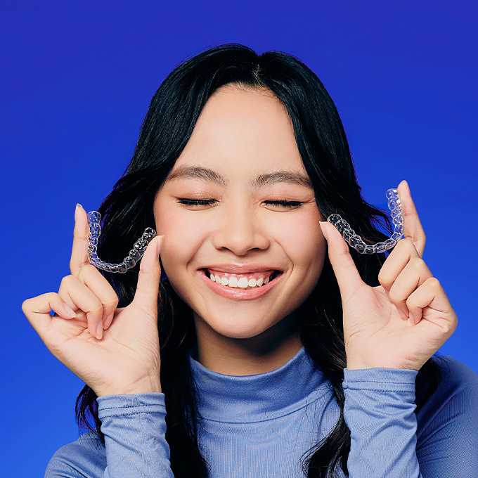 Girl holding clear aligner