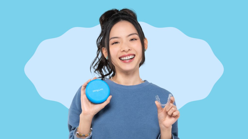 Women in blue holding clear aligner and Zenyum aligner case