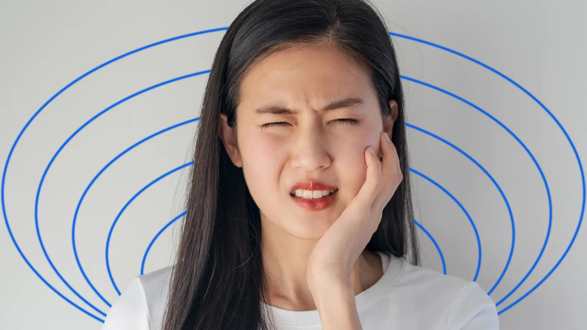 A woman experiencing discomfort after removing braces