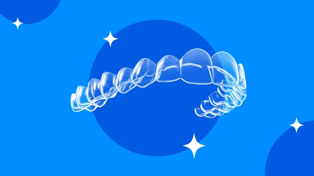A set of Zenyum clear aligners against a dark blue background.